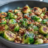 Tender Brussels sprouts pair with seasoned ground turkey in a one-pan skillet, topped with Parmesan cheese.