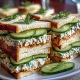 Delicate finger sandwiches with bright lemon butter, crisp cucumber, and fresh herbs for a perfect Mothers Day tea.