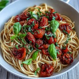 Tender slow-roasted tomatoes elevate this garlic oil pasta dish beautifully.