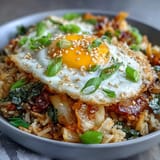 Perfect bowl of quick kimchi fried rice, vibrant and satisfying, with tender toppings.