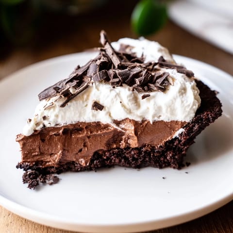 Rich, dark Mississippi Mud Pie, drizzled with chocolate shavings, is a classic American dessert.