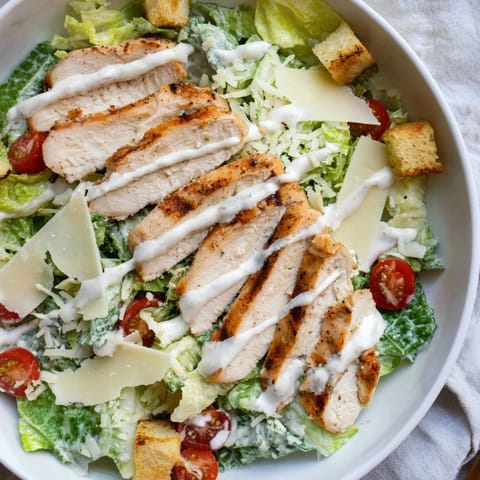 Creamy Greek yogurt dressing is drizzled over the fresh salad, with croutons and shaved Parmesan adding texture to this protein-packed main dish.