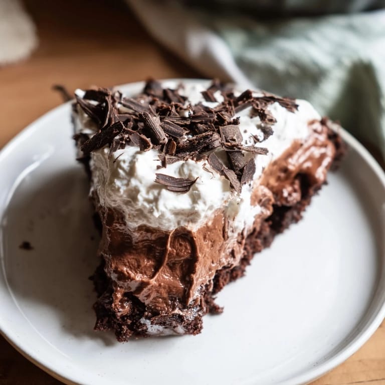 This creamy Mississippi Mud Pie features a fudgy brownie base and is ready to be served.