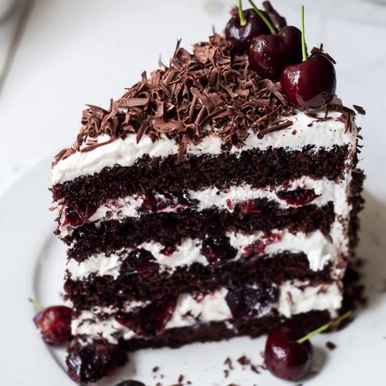 This Black Forest cake boasts decadent chocolate cake, bursting with cherry filling, topped with whipped cream.