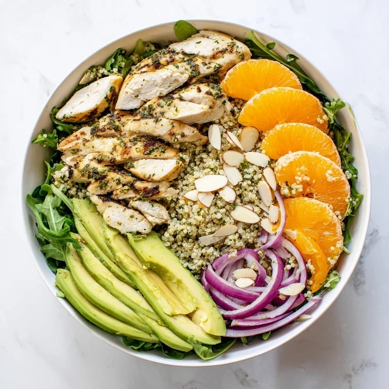 Healthy meal-prep friendly Citrus Herb Chicken Salad Bowl with mixed greens, quinoa, and citrus dressing ready for a satisfying lunch.