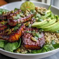 Freshly roasted butternut squash steak bowls feature fluffy quinoa, creamy avocado, and smoky steak drizzled with lime-cilantro dressing.